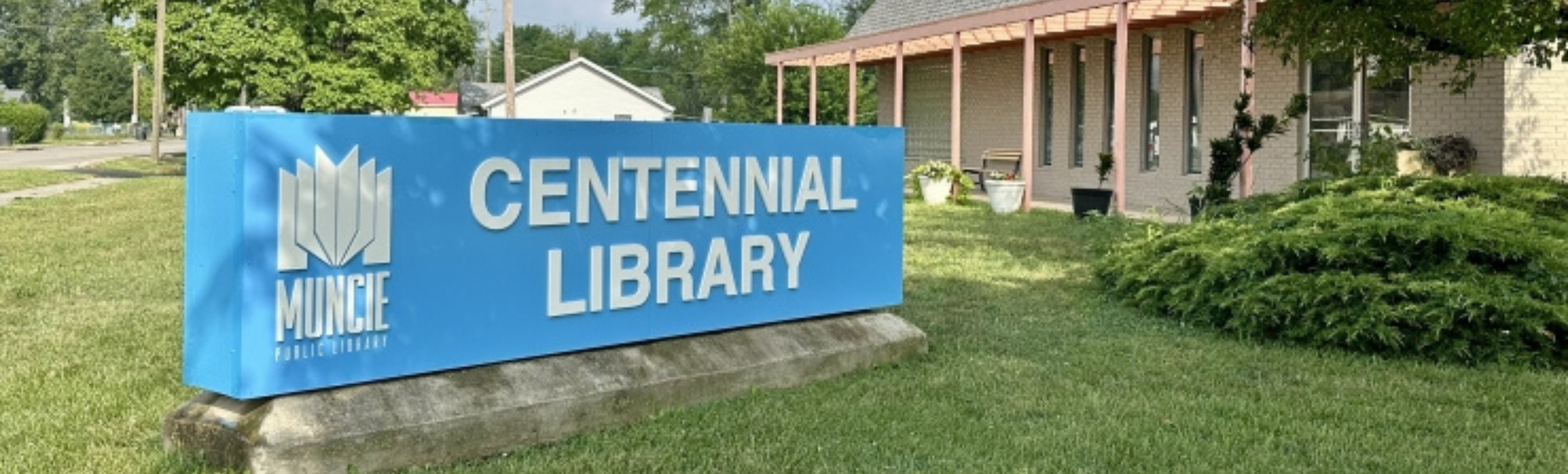 A photo of Centennial Library's sign and building exterior.