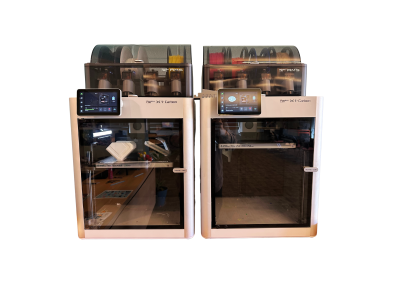 Photo depicts two of the three Babmu Lab 3D printers at Centennial Library.