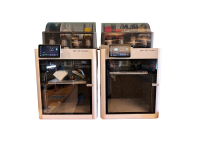 Photo depicts two of the three Babmu Lab 3D printers at Centennial Library.