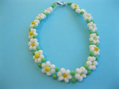 Craft to go: Daisy Chain Bracelet made with white, yellow, and green seed beads.