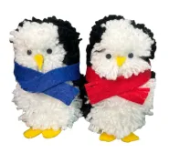 Example of completed pom-pom penguin craft. One has a blue scarf and one has a red scarf.