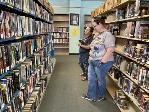 Photo of people looking at books at a Friends book sale. 