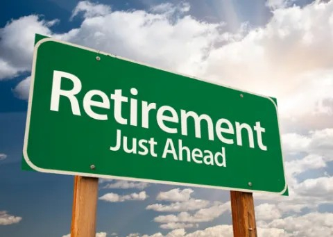 A green road sign that says "retirement just ahead."
